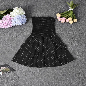 Nahaufnahme eines schwarzen Polka-Dot-Bandeau-Kleids mit elastischer Taille und Rüschensaum