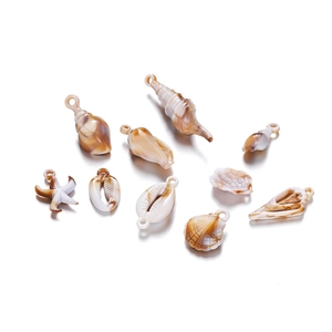 Macro detail of acrylic ocean pendants with marble texture and hanging loops for DIY jewelry