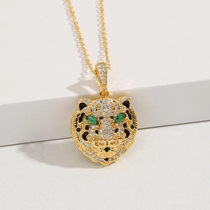 Gold-plated leopard pendant necklace with zircon crystals and green gemstone eyes