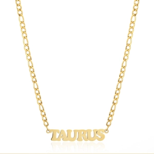 Macro shot of gold-plated 304 stainless steel necklace with Taurus zodiac pendant and Figaro chain