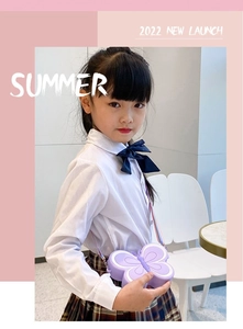 Close-up of a purple silicone butterfly shoulder bag with colorful rainbow strap for kids