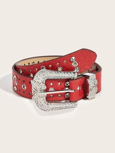 Detail of red crocodile skin belt with sparkly rhinestone buckle and star cutouts