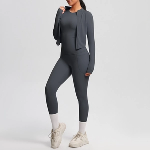 Detail of slim-fit gray yoga set with zippered jacket and pocket leggings