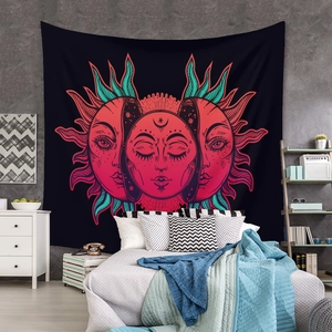 Detail of bohemian tapestry featuring sun, moon, and triple goddess icons on a bedroom wall
