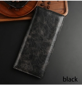 Detail of vintage black long leather wallet with cracked texture in a business setting