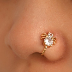 Golden spider U-shaped faux nose ring with zircon stones shown on a model for non-pierced nose