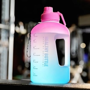 Close-up of pink-blue gradient fitness bottle with time markers and portable handle