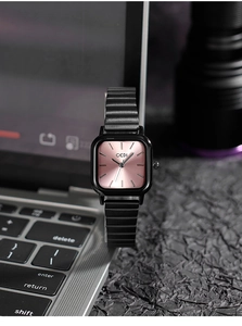 Close-up of GEDI square women's watch with pink dial on a laptop keyboard
