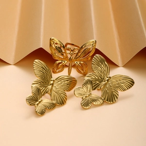 French vintage gold butterfly jewelry set with ring and earrings on a gold fan