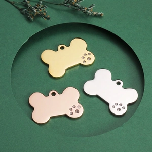 Dog bone ID tags in gold, silver, and rose gold with crystal paw print accents