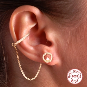Detail of 925 sterling silver chain cuff earring with zircon stud on ear model