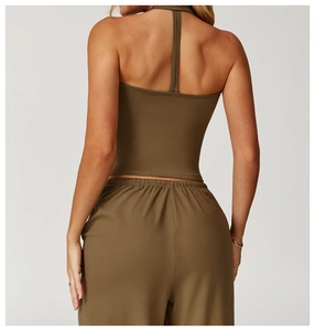Deep olive green backless yoga vest with crossover straps and matching wide-leg pants