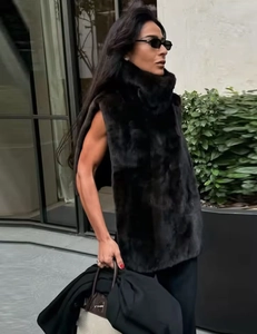 Dettaglio del gilet in ecopelliccia nera con collo alto e texture soffice senza maniche