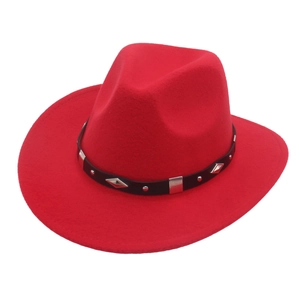 Close-up of red felt cowboy hat featuring black leather band and silver metal studs