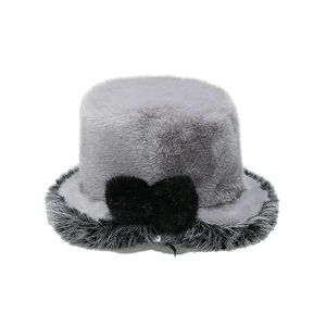 Detailed view of the soft grey faux fur bucket hat with a black bow and plush trim
