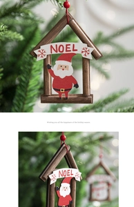 Detailed view of a wooden Noel cottage ornament with Santa Claus on a Christmas tree