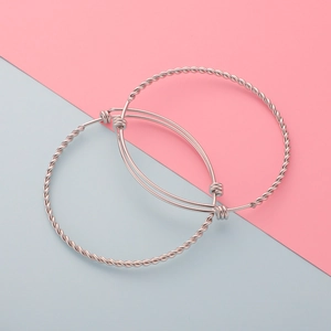 Detailed view of silver stainless steel twisted bangle and adjustable thin cuff bracelet