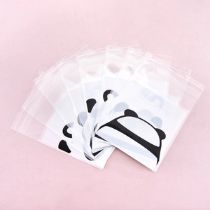Transparent plastic self-sealing cookie bags with cute panda patterns on pink background