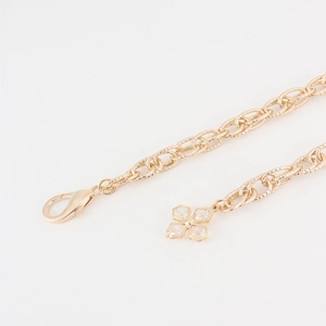 Elegant gold waist chain for women with sparkling crystal flower pendant on white background