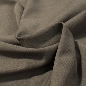 Close-up of brown knit fabric texture showing fine mesh structure and soft drape detail