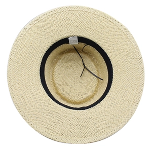 Detail view of straw hat interior showing 100% paper material label and sweatband