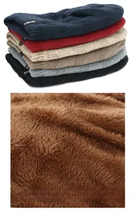 Detailed close-up of winter knit beanie hats with thick brown faux fleece lining