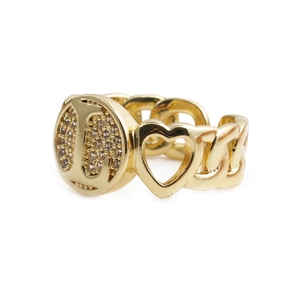 Detail view of gold heart ring with letter L engraving and pavé crystal accents