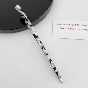 Detailed view of acetic acid hair pin featuring black and white marble pattern design