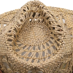 Interior view of hand-woven natural straw sun hat showing detailed texture and craftsmanship