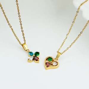 Gold necklaces featuring colorful zircon clover and heart shaped pendants on white background