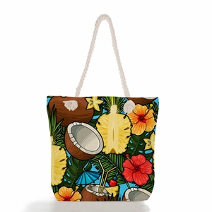 Close-up detail of tropical summer tote bag with rope handle and pineapple coconut pattern