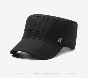 Close-up of black flat top military cap with side metal logo and canvas texture