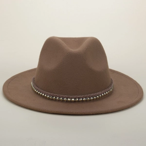 Detailed texture of brown wool fedora with woven band and gold metal rivet accents