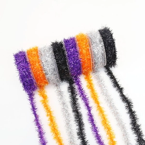 Close-up of purple, orange, silver and black Halloween metallic tinsel garland for DIY decor