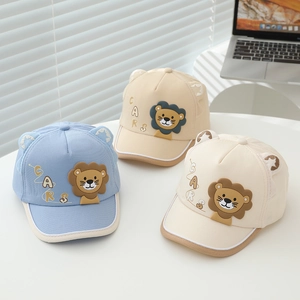 Detailed close-up of cartoon lion baseball caps with 3D ears in blue, beige and cream