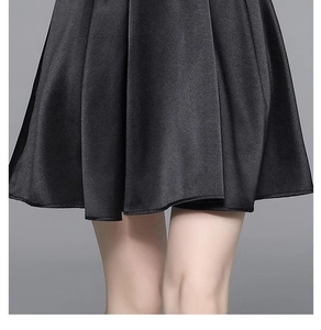 Detail shot of black satin dress showing high-gloss fabric texture and elegant drape