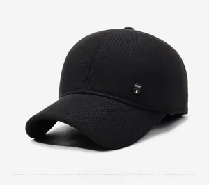 Detail of black winter baseball cap showing the knitted texture and Sport fabric label