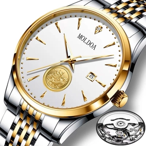Detail of automatic watch dial featuring sailboat emblem and luminous date display