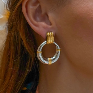 Elegant gold and silver dual-tone stainless steel hoop earrings for women on model