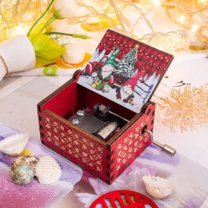 Handcrafted red wooden music box with gold patterns and festive Christmas illustration