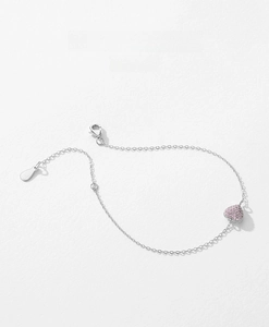 Macro shot of S925 sterling silver chain with pink pavé heart pendant and lobster clasp