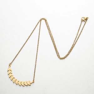 Detailed shot of golden olive leaf pendant necklace with thin chain and lobster clasp