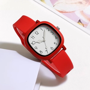 Detailed close-up of a square red watch with white dial and red silicone strap