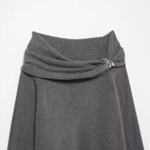 Cold shoulder knit top in dark gray featuring metallic chain links and draped neckline