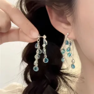 Blue crystal tassel drop earrings with silver metal chains in a multilayered design