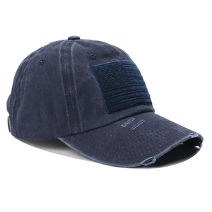 Detailed close-up of navy blue washed baseball cap with USA flag patch and distressed brim