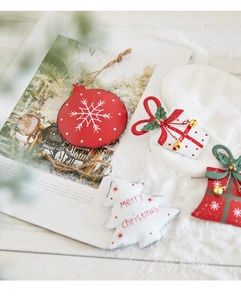 Detailed close-up of festive red and white metal Christmas tree hanging ornaments