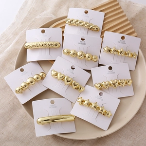 Gold heart and star hair clips set on a display card for minimalist women hair styling