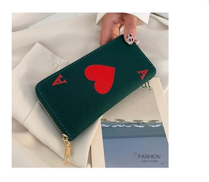 Detail of dark green canvas clutch featuring Ace of Hearts print and golden zipper