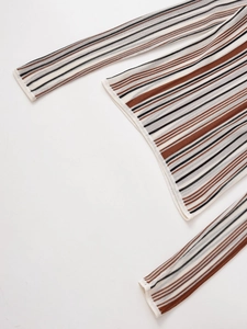 Close-up of the V-neck linen-blend knit sweater featuring classic multi-color stripes
